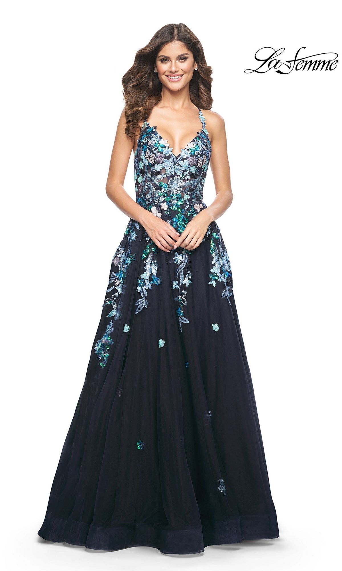 Woman in a floor-length, sleeveless navy La Femme Sequin Flower-Print Long Prom Dress 32023 with blue and green floral embroidery, smiling.